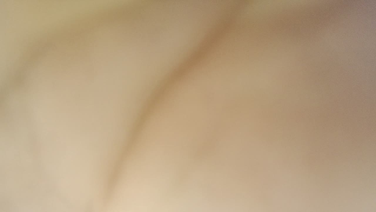 Close-up skin detail fills the frame at the start of the Los Cabos clip, with no visible faces or wider location context.