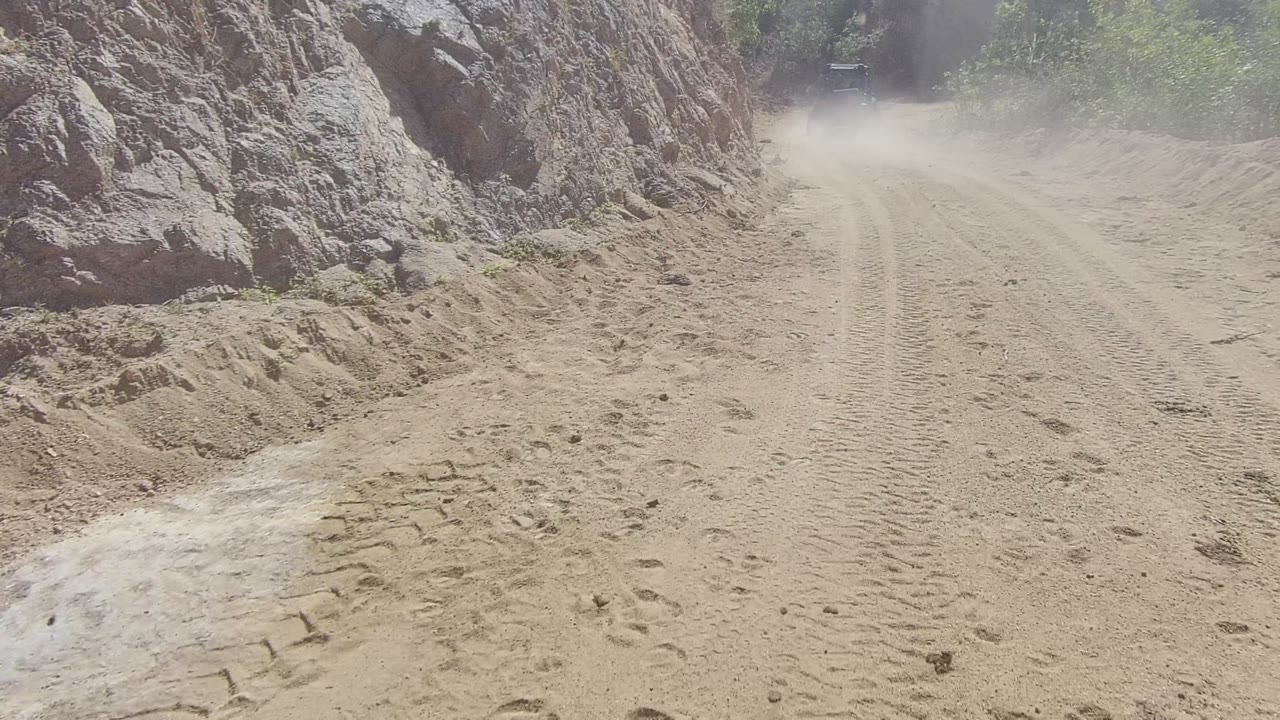 Rocky roadside and dusty unpaved track