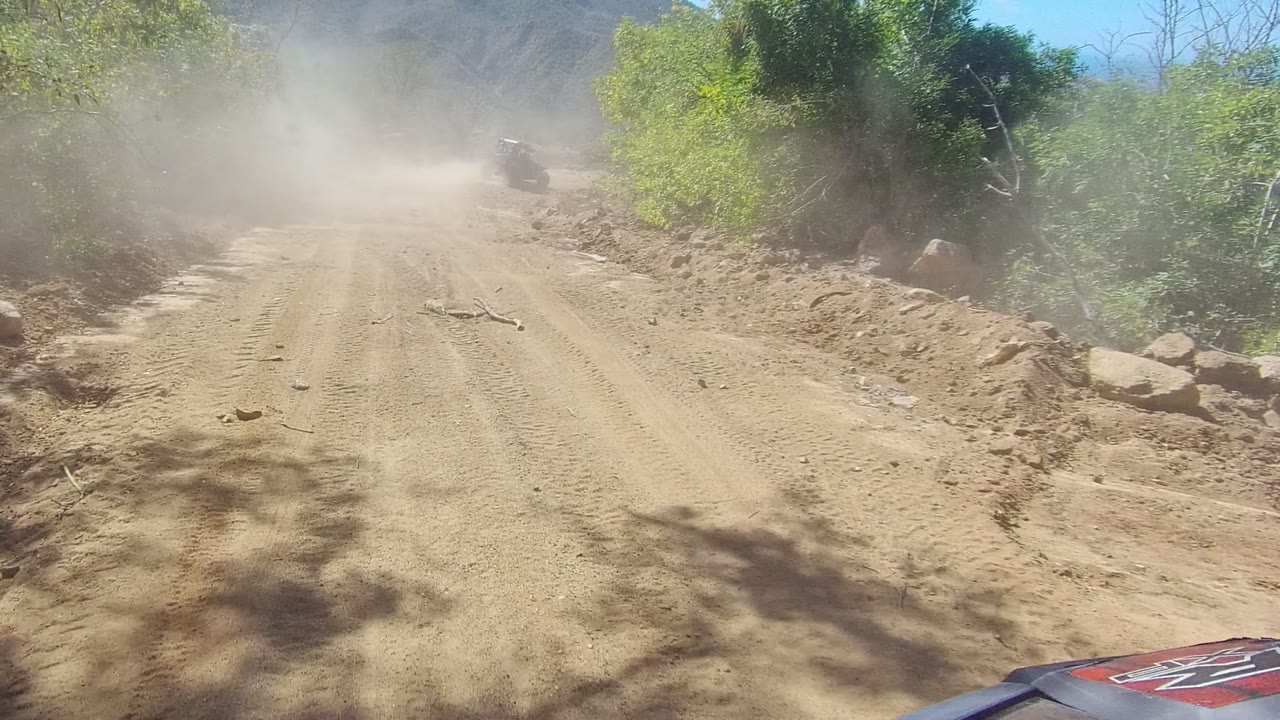 Dust cloud hanging over sandy road