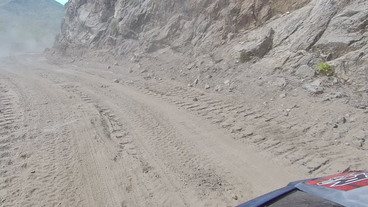 Winding dirt road between steep rocky walls