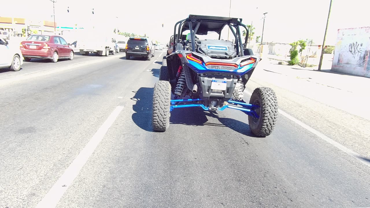 At two seconds, the UTV is still shown from behind on the Los Cabos road, with its blue suspension visible and no people visible around the vehicle.