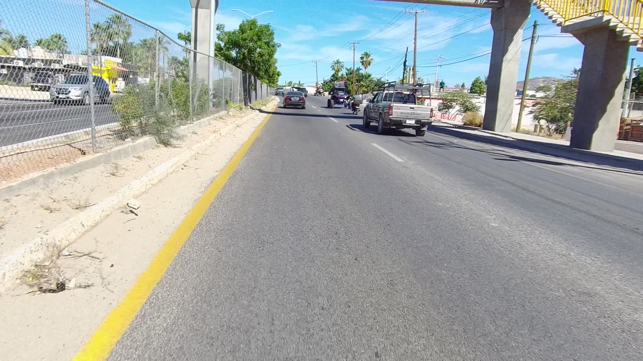 Roadway passing under the overpass with vehicles ahead