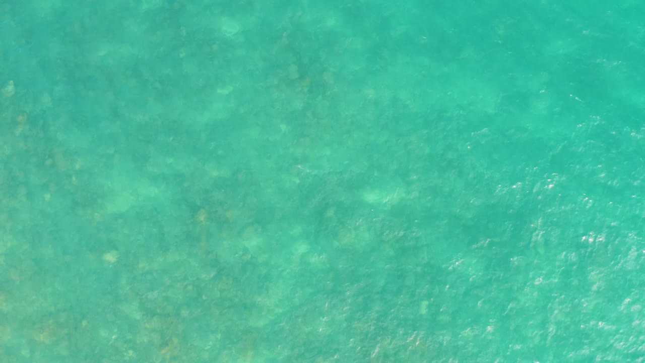 Clear green-blue water with soft surface shimmer