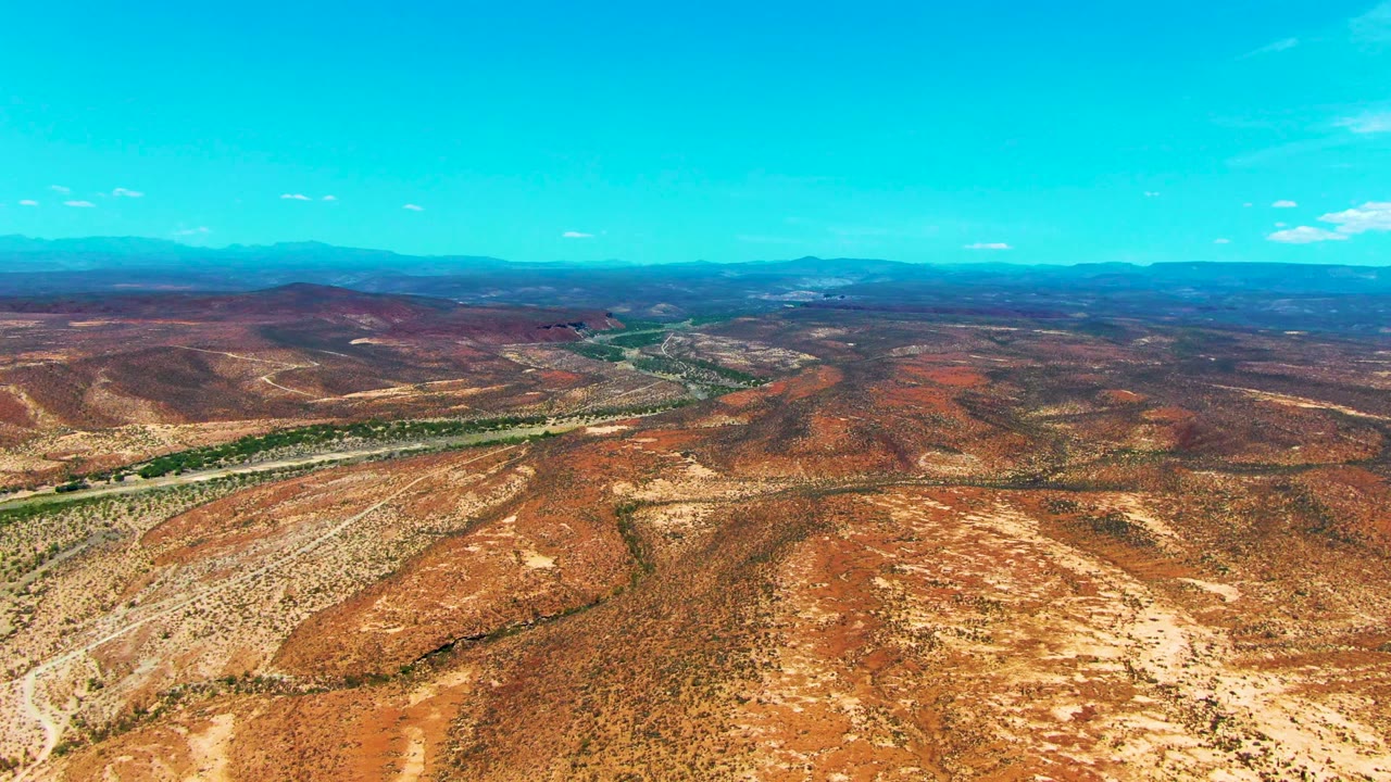 Desert road and scrub-covered hills seen from above