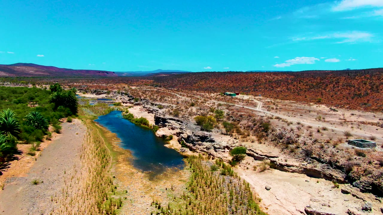 River channel, rocky wash, and dirt road crossing arid terrain.