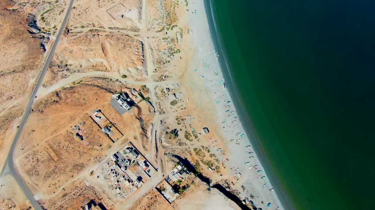 Third frame shows San Juanico's pale beach strip beside dark green water, with rectangular construction pads, dirt access routes, sparse vegetation, and no visible people.