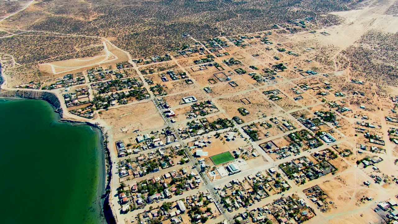 Drone view of desert town blocks and shoreline