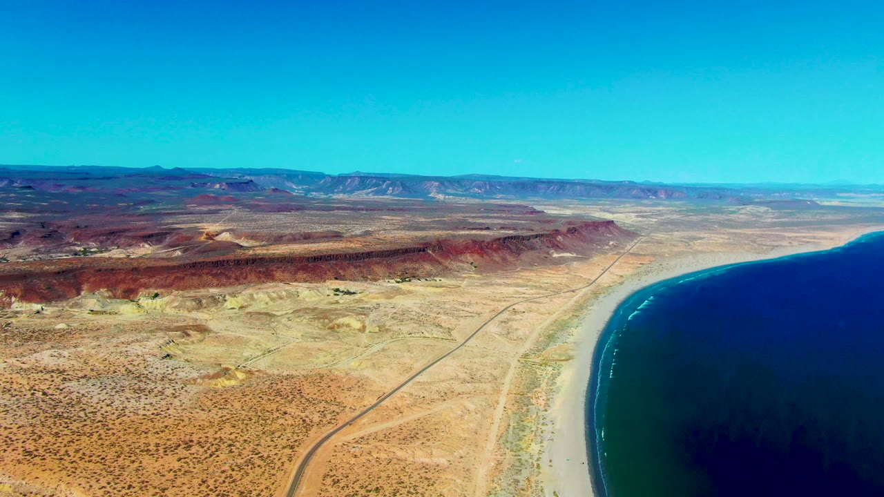 Wide desert coast with road running toward the beach