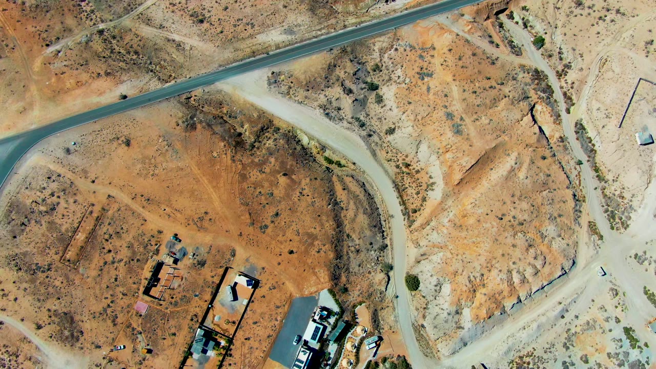 Aerial desert intersection with structures near lower edge