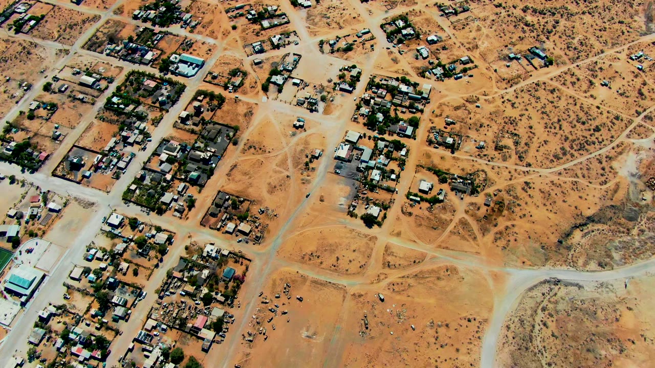 Overhead desert neighborhood with roads and clustered homes