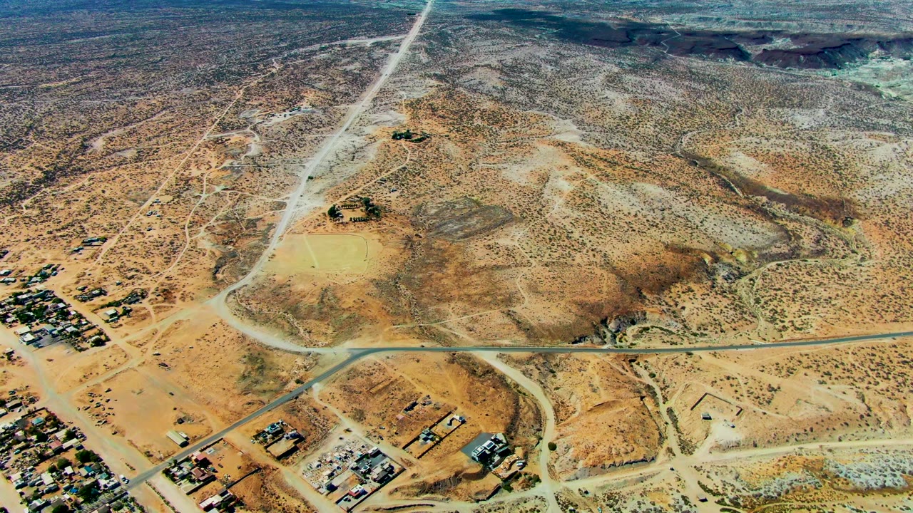 Overhead desert roads beside scattered buildings