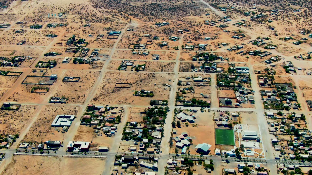 Aerial view of roads, homes, and desert lots