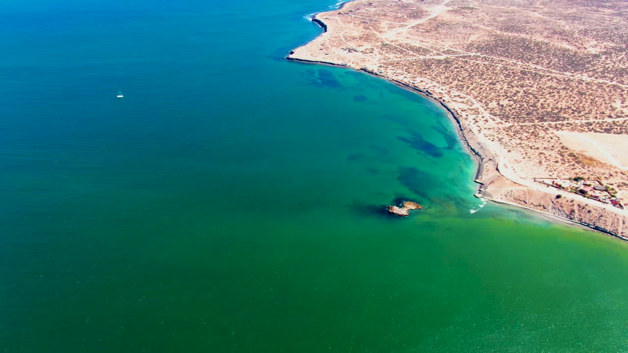 Coastline receding beside turquoise ocean
