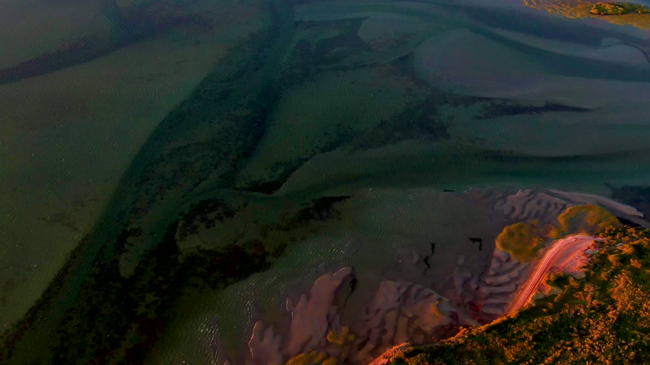 Overhead view of winding channels with dimmer sunset color.