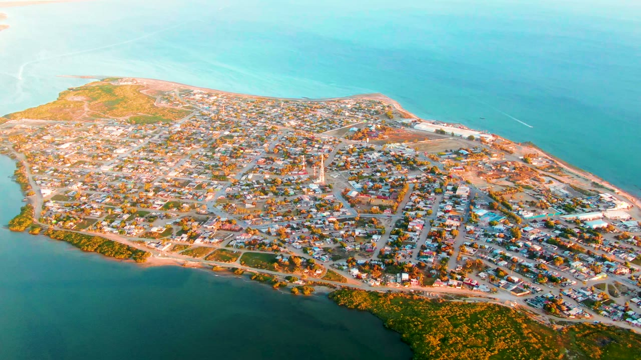 Drone view over coastal buildings and shoreline water