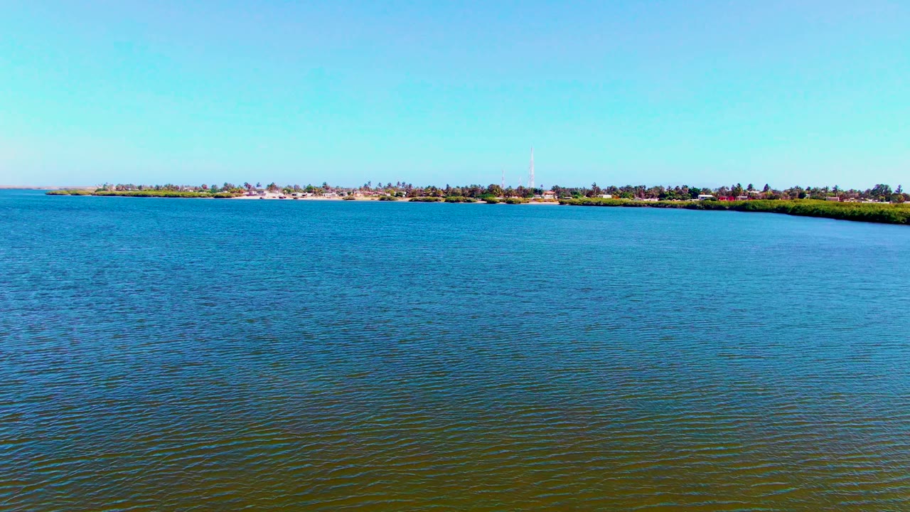 Calm water foreground with low shoreline across the horizon.