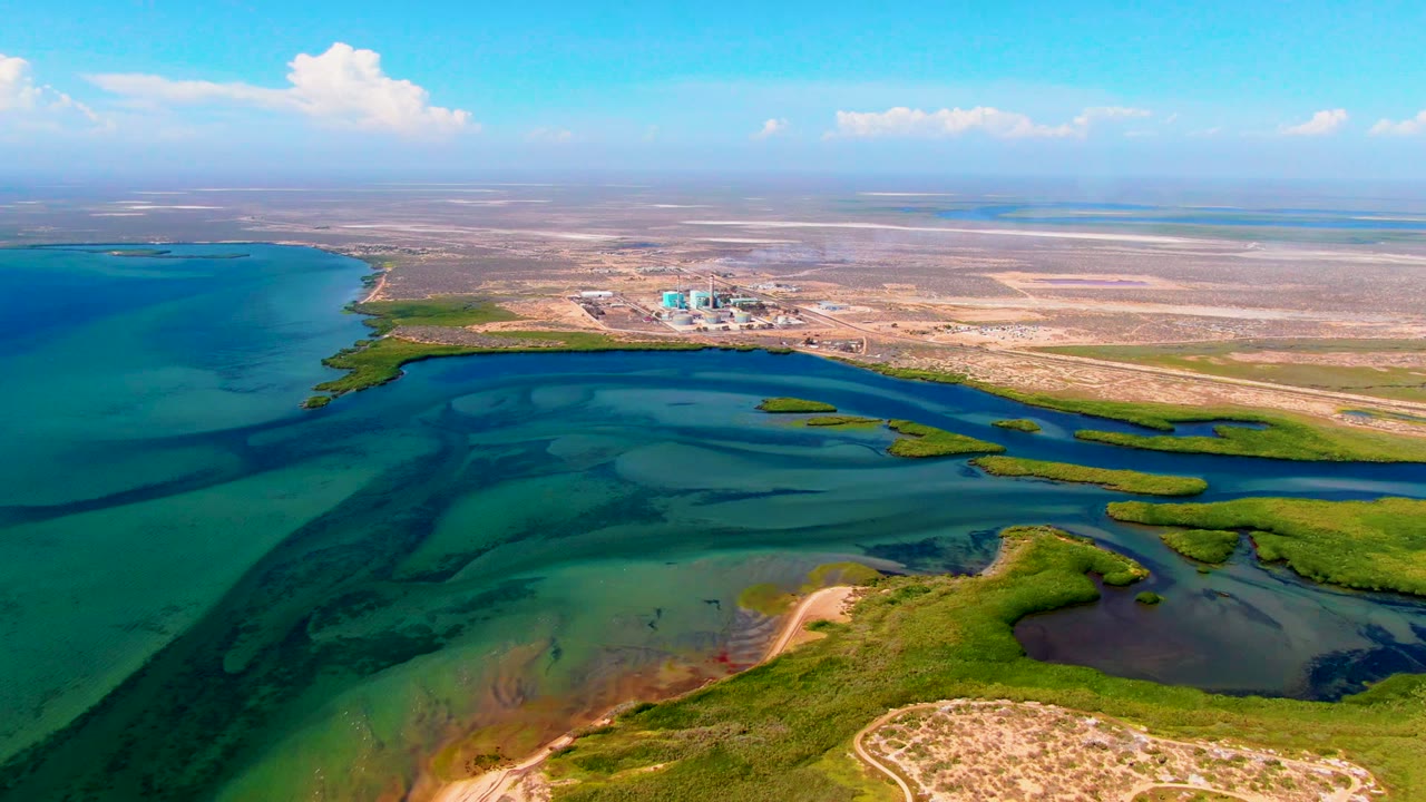 Drone view of coastal water channels around a pale sandbar