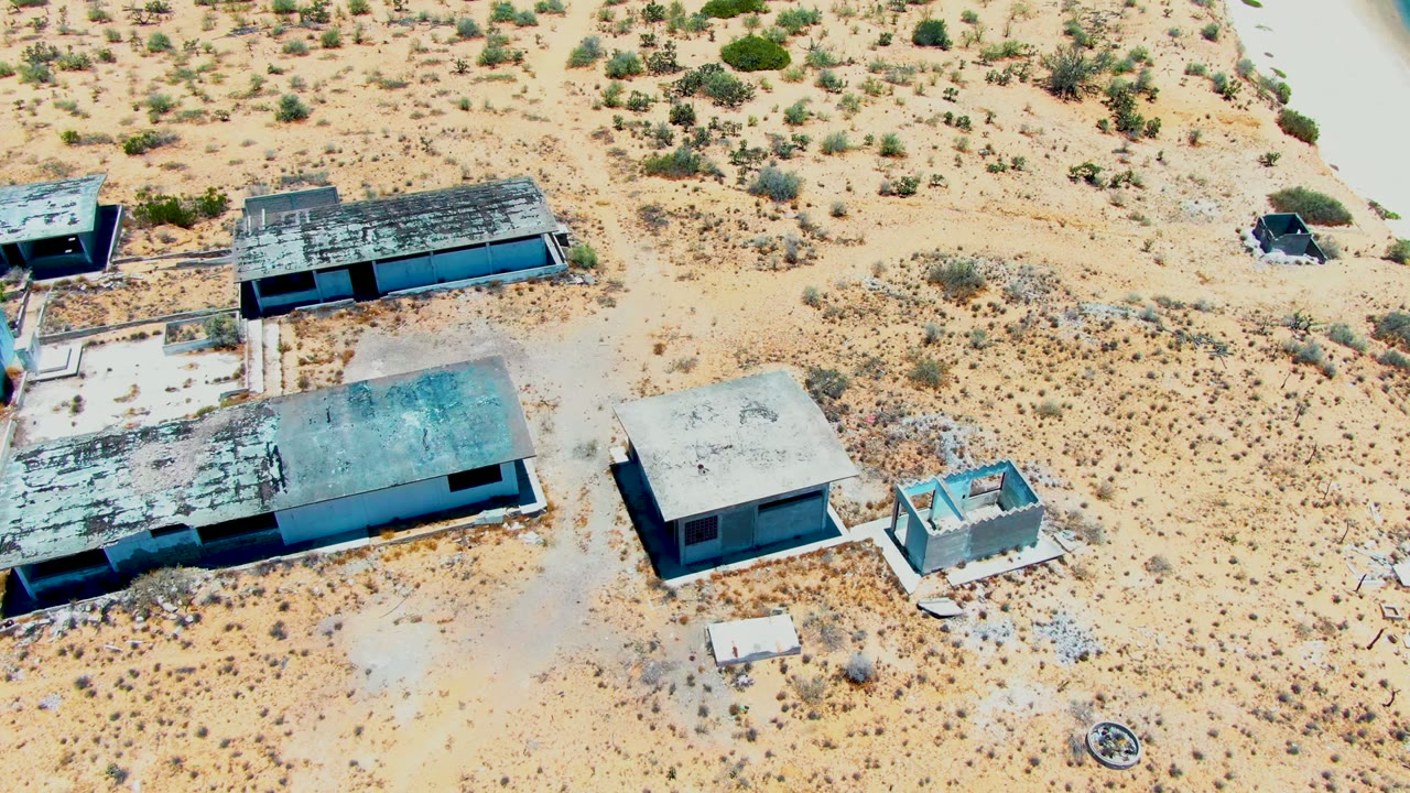 Overhead desert view with several dilapidated concrete structures