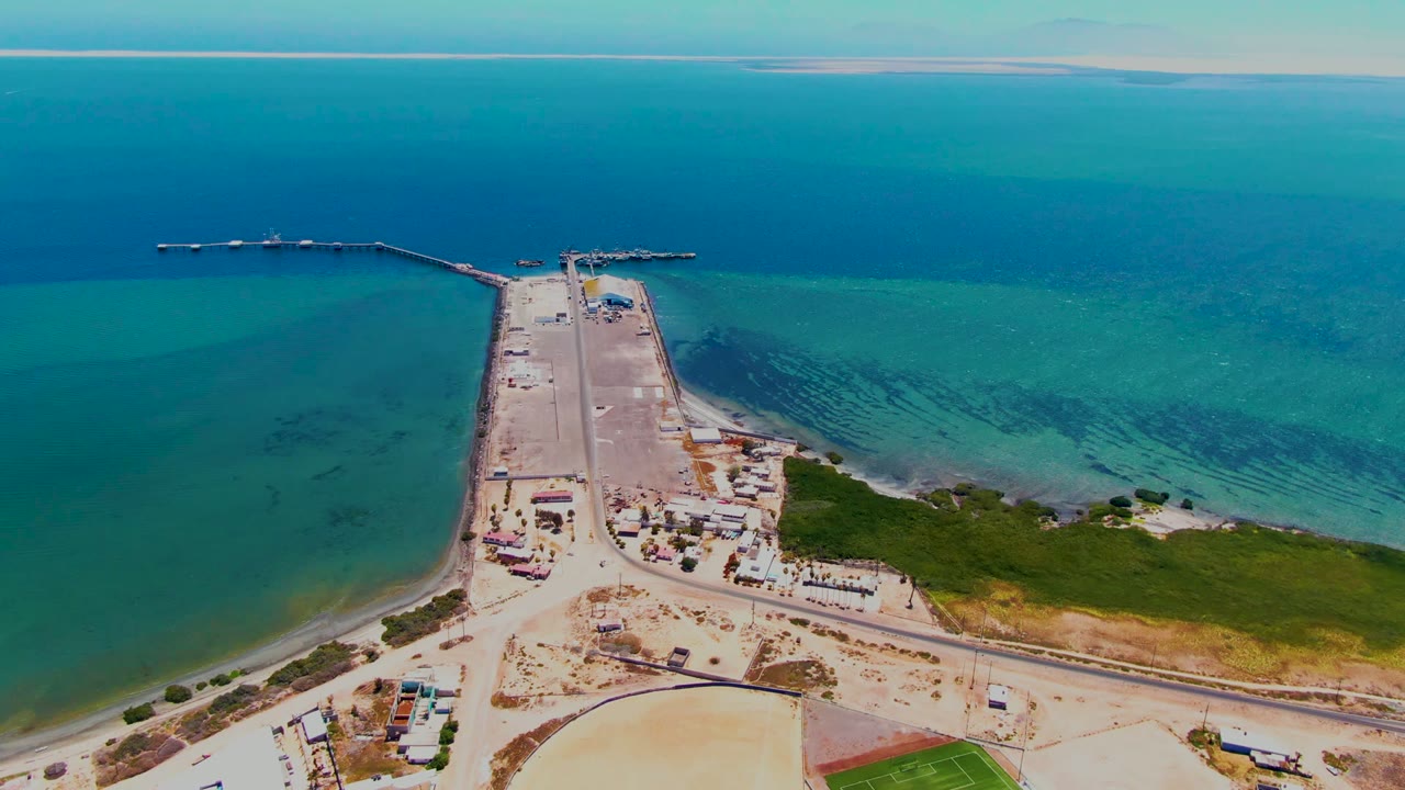 Runway and jetties bordered by shallow turquoise water