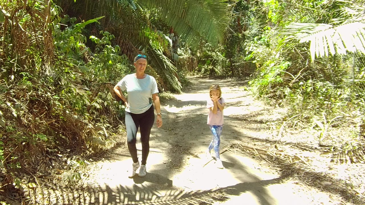 Woman and child farther along a shaded dirt trail.