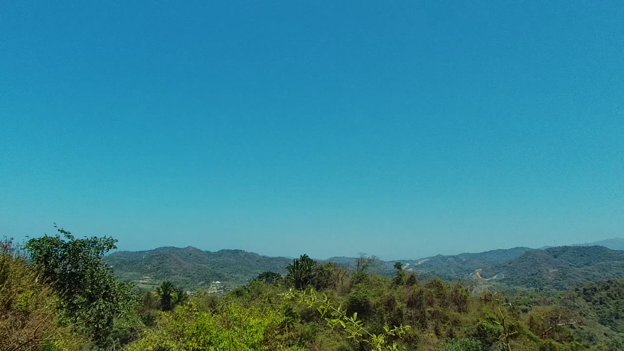 Wide San Pancho, Nayarit hillside landscape with dense green vegetation, distant ridgelines, and no visible people at the start of the clip.