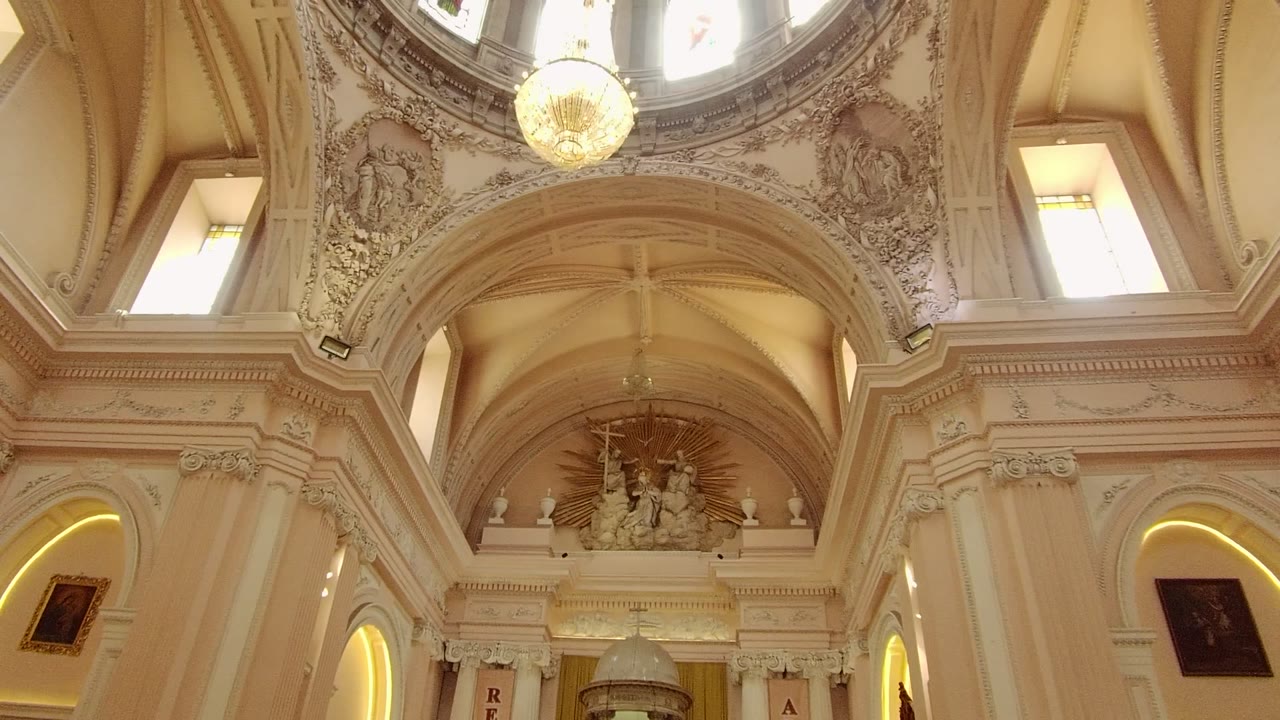 Church dome interior with chandelier and stained glass windows