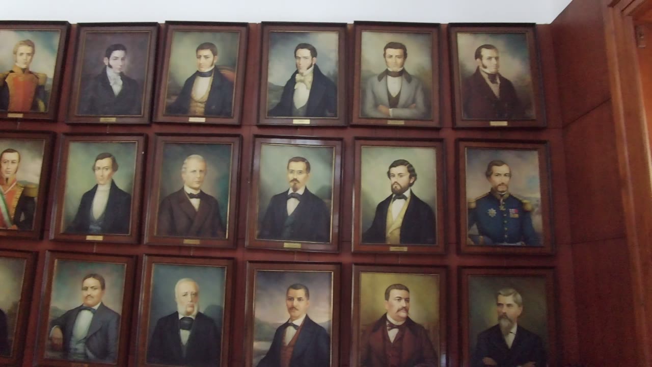 A wider crop of the Guadalajara wall shows multiple columns of framed male portraits, with a vertical wood panel visible at the right edge.