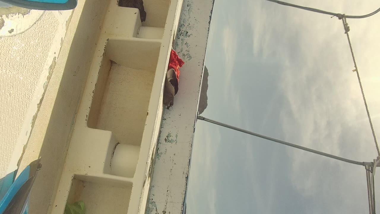 Interior section of a cream boat deck seen at a steep angle.