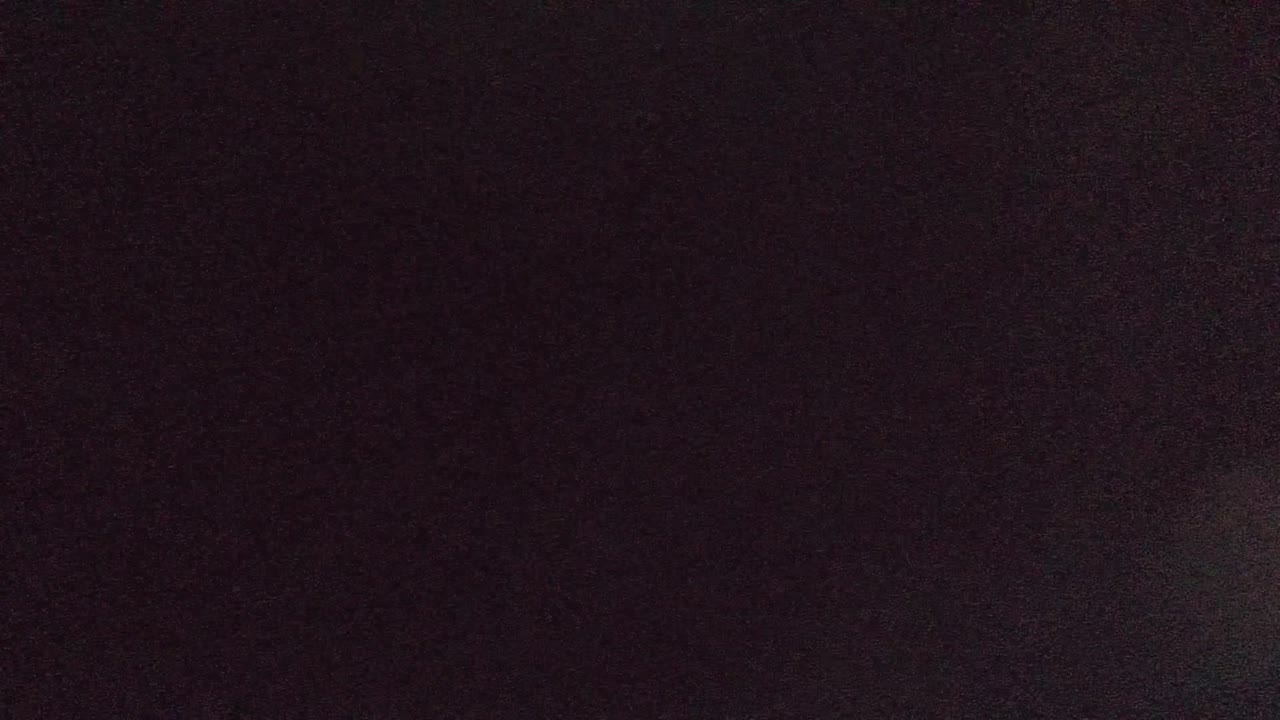Very dark opening frame from the Cabo Pulmo water clip, with little visible detail and no visible people.