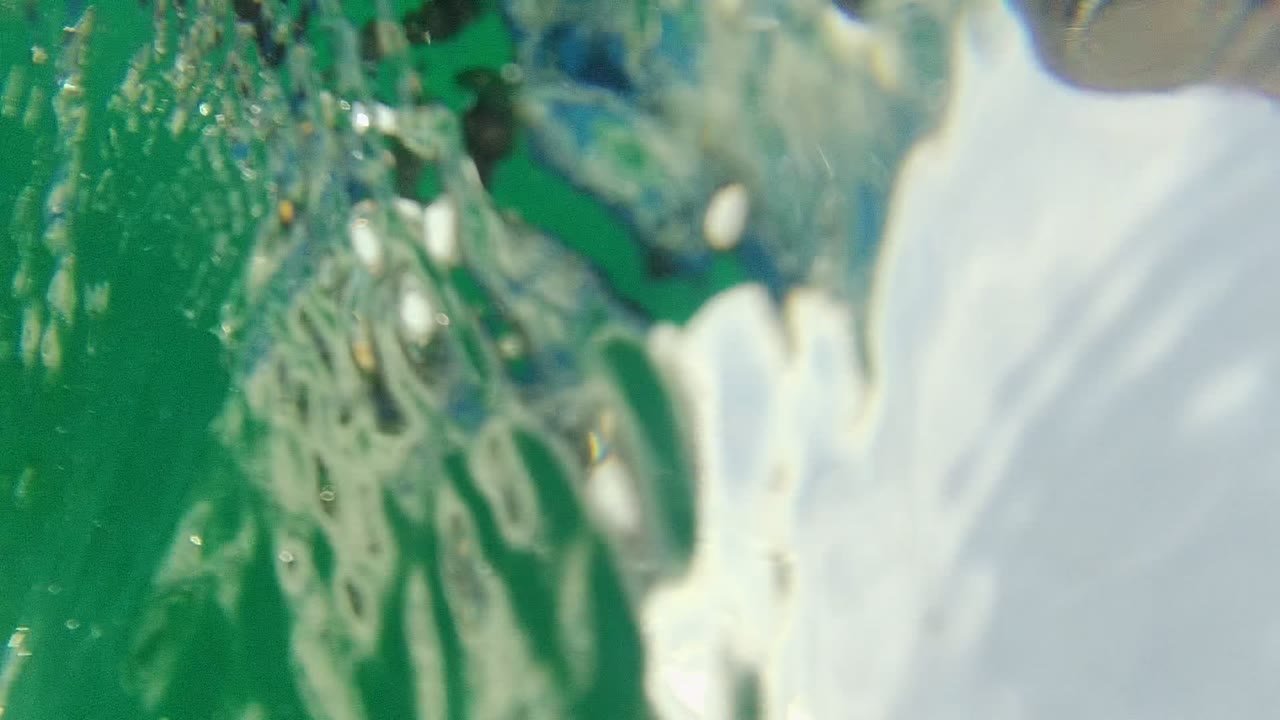 green water and bubbles near a swimmer