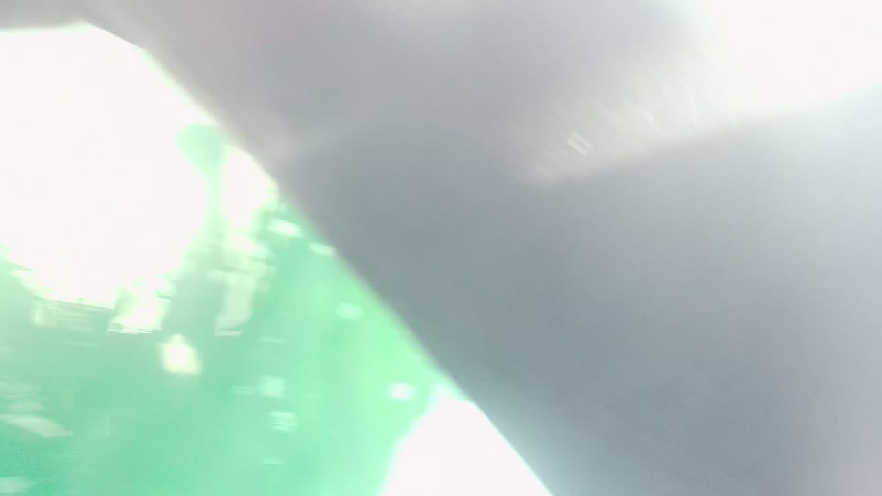 The Cabo Pulmo waterline is partly blocked by dark hull material and bright glare on green water, with no visible people.