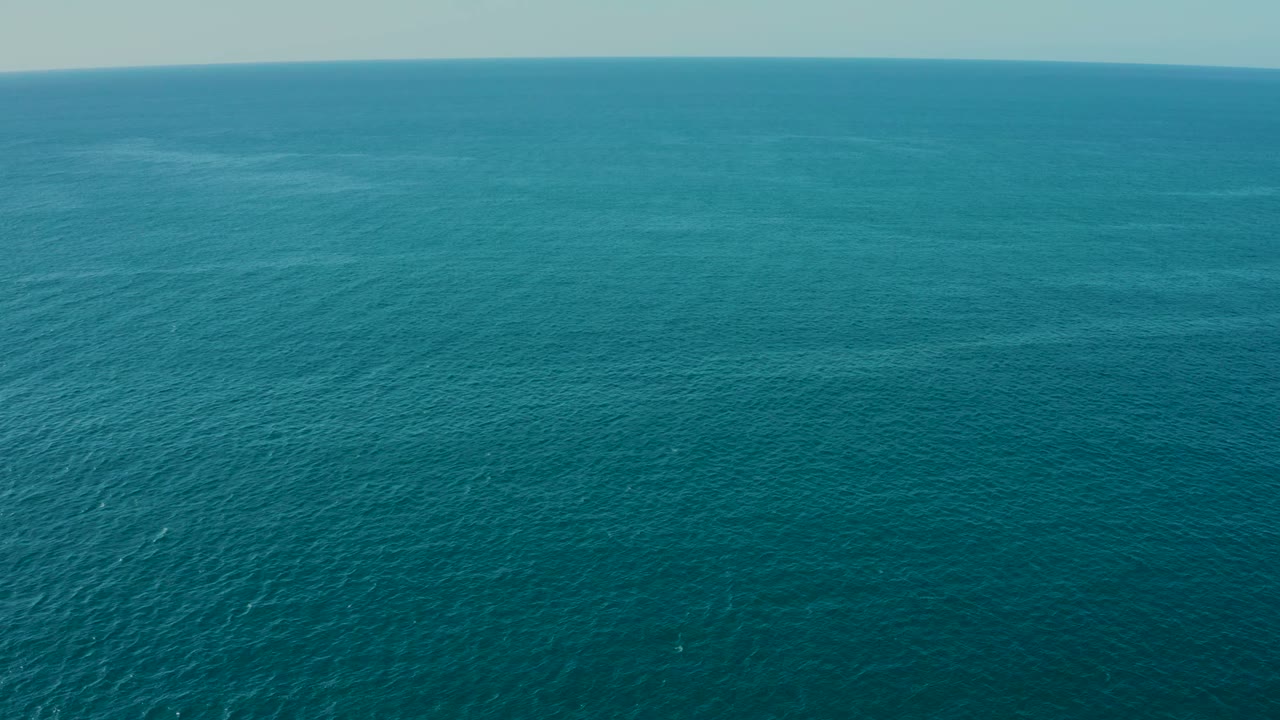 Ocean surface with bright sunlight shimmer along the left side