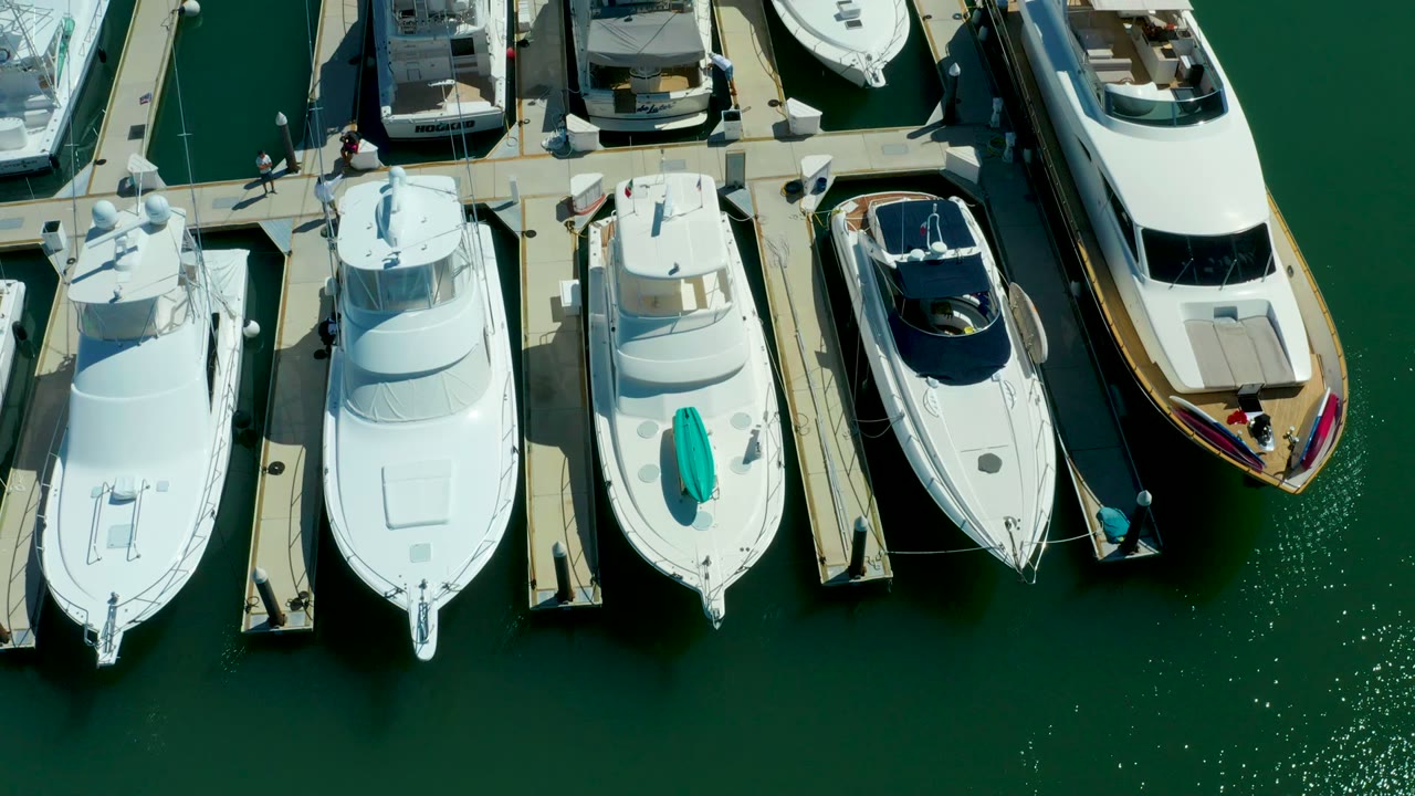 Aerial view of yachts moored beside narrow marina piers