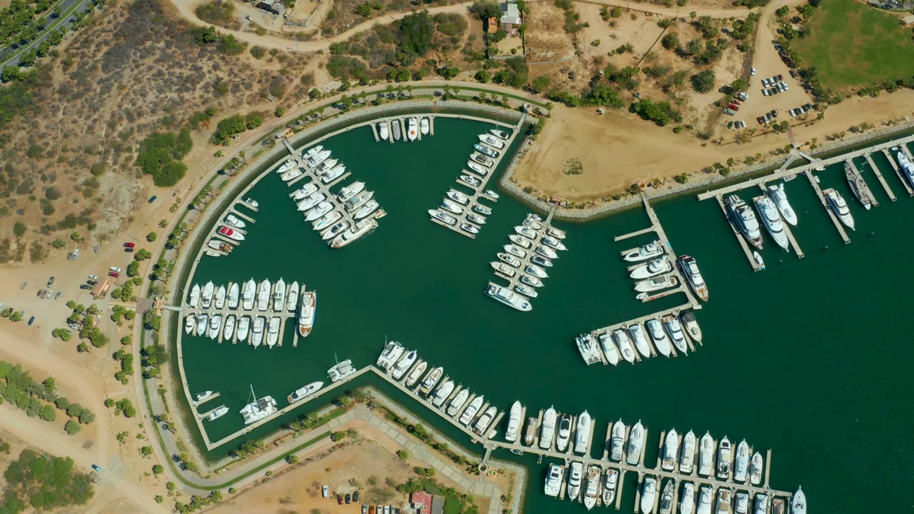 Aerial marina view with white yachts docked at piers