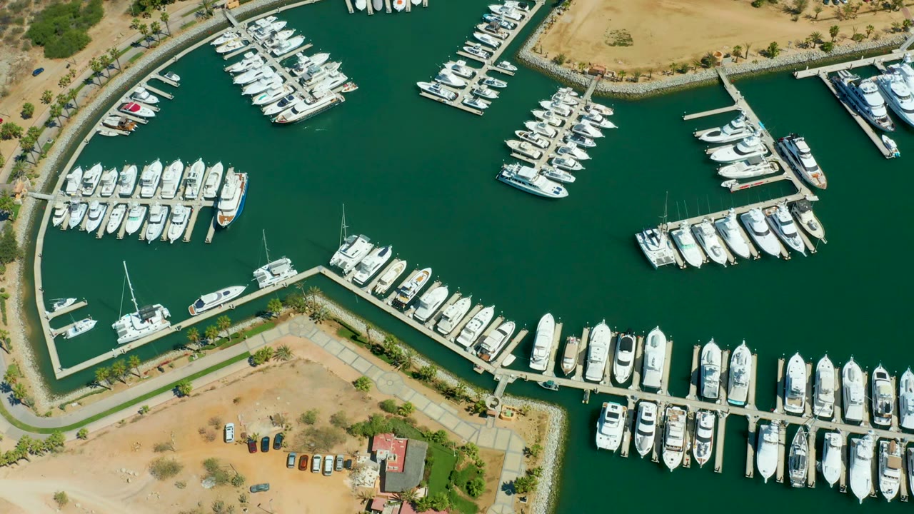 Aerial marina basin with docks and moored yachts
