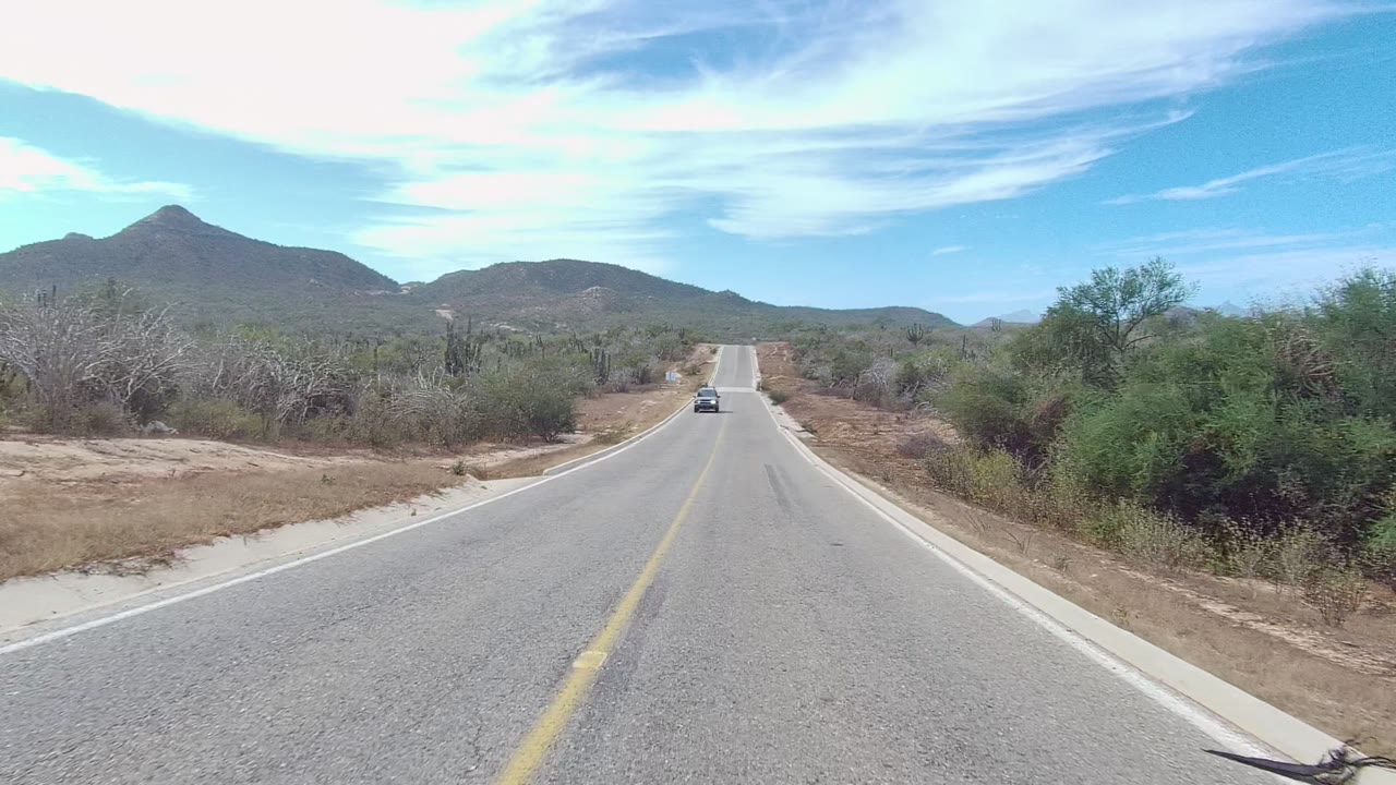 Vehicle approaching on a straight arid road