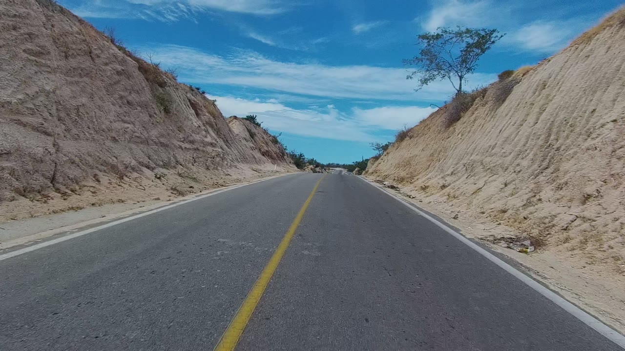 Road curving through dry hillside cut