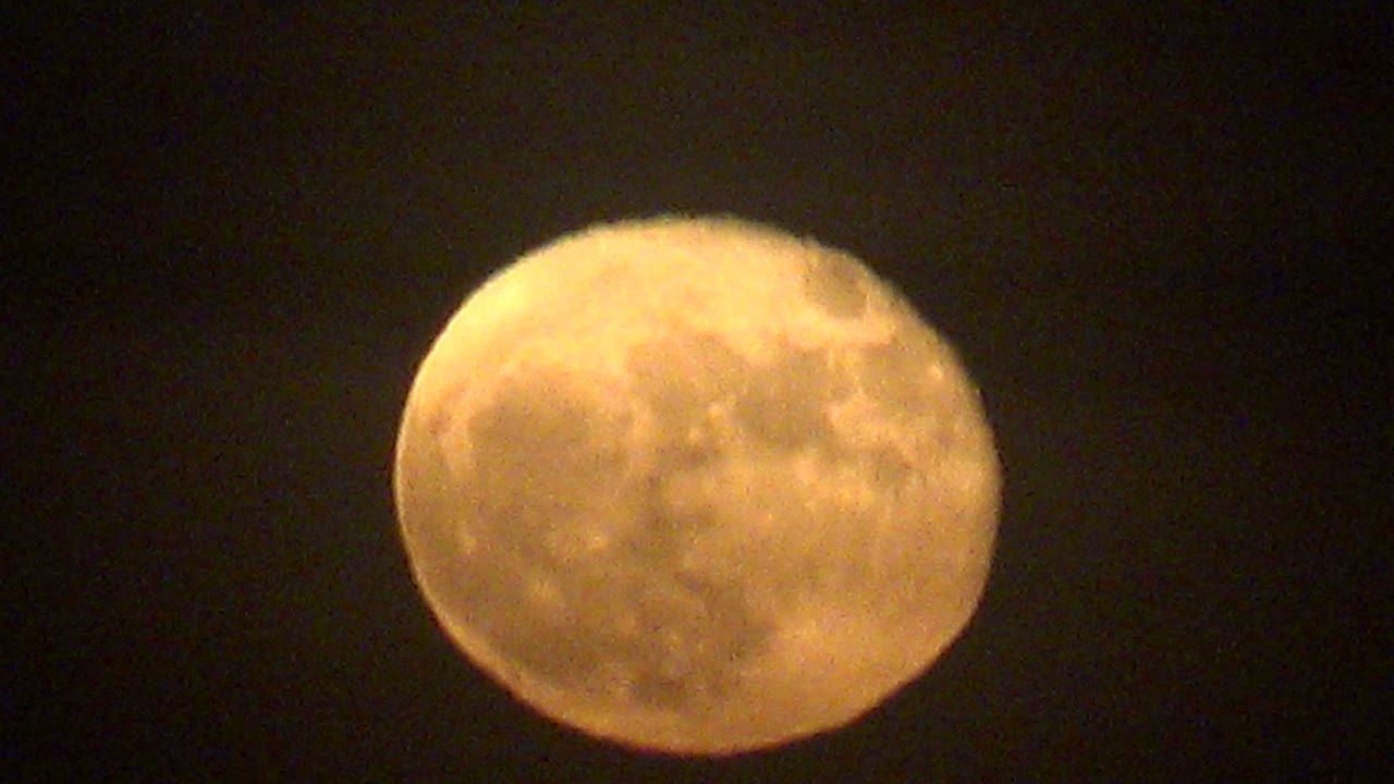 Warm yellow full moon centered in the dark La Bocana night sky, with faint cloud softness across the lunar surface and no visible people.