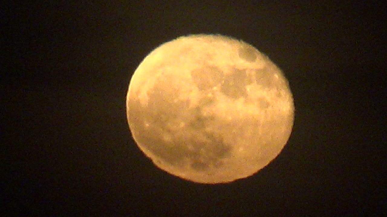 Full moon with faint cloud haze in dark sky