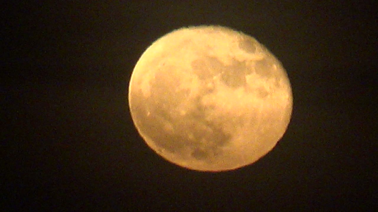 A yellow full moon sits against black sky over La Bocana, with slight cloud texture visible near the lower and side edges and no visible people.