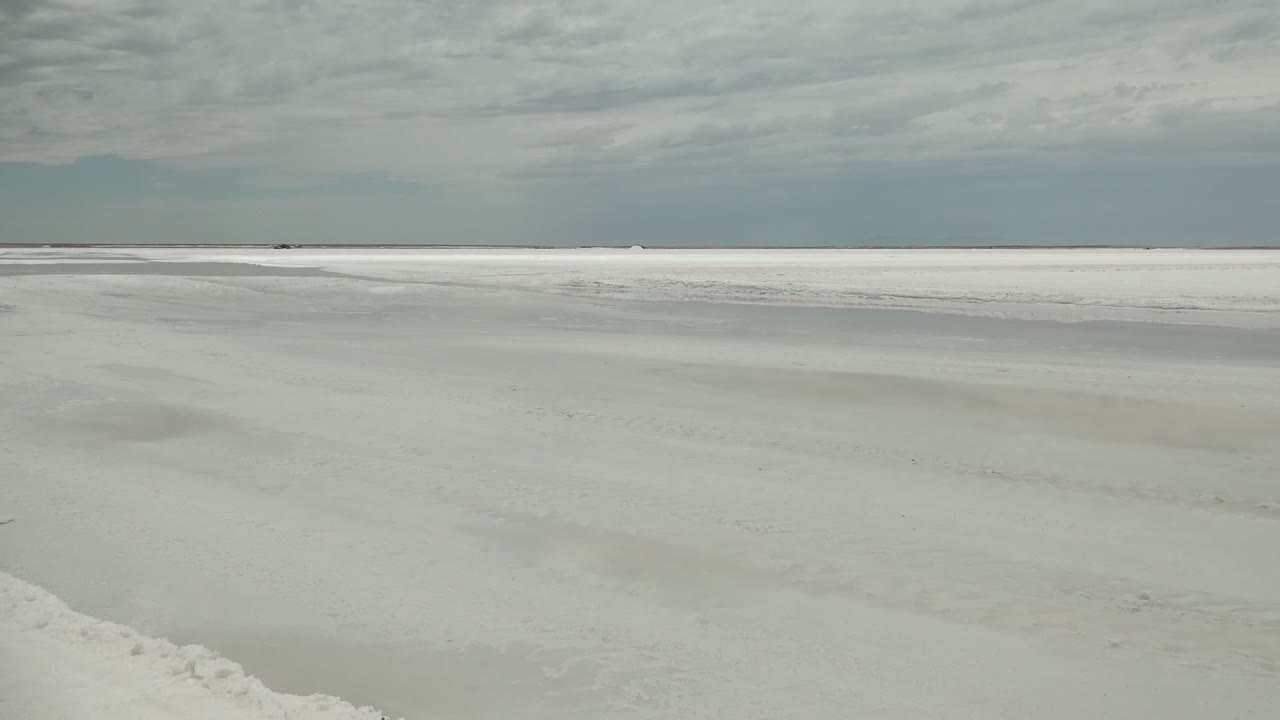 Wide view of a pale white flat surface in Guerrero Negro, Baja California Sur, with a low horizon, gray overcast sky, and no visible people.