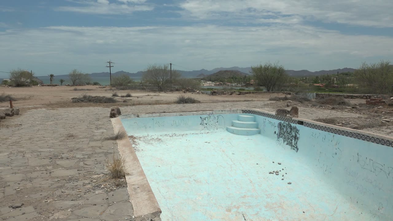 Third frame shows the empty pool from the deck in Mulege, Baja California Sur, with chipped blue walls, dark tile trim, graffiti, a sandy lot, desert shrubs, and no visible people.