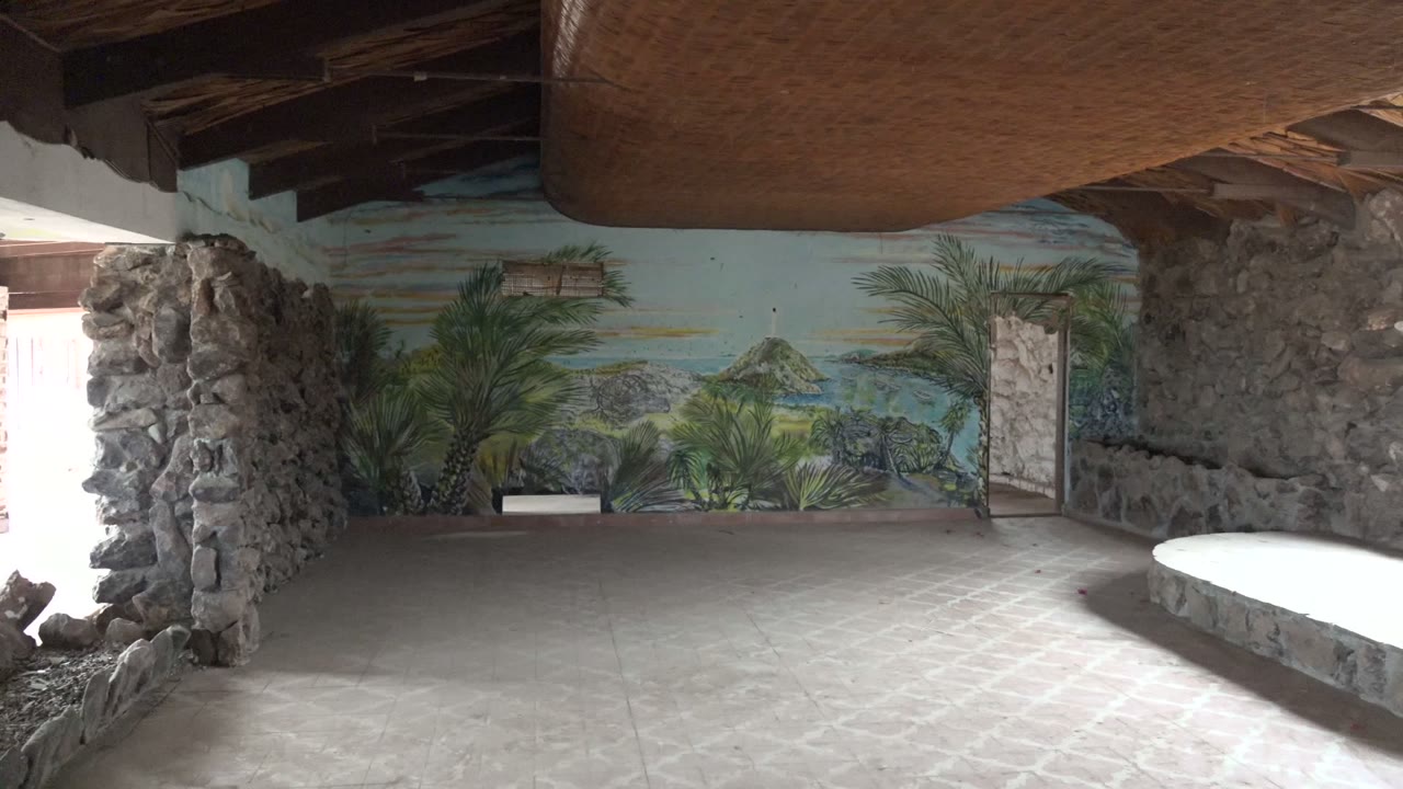 Tropical mural across stone-walled interior