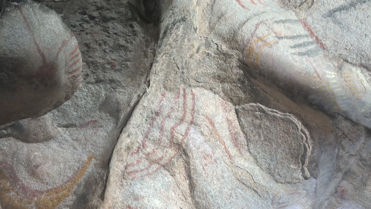 Third frame shows the same close Santa Rosalia rock art area with red linear markings crossing pale gray stone and no visible people.