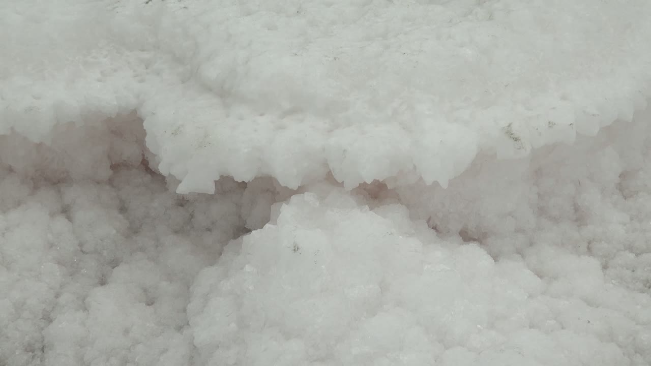 Close-up in Guerrero Negro, Baja California Sur, Mexico, showing a thick white ice edge above clustered frozen texture, with no visible people.