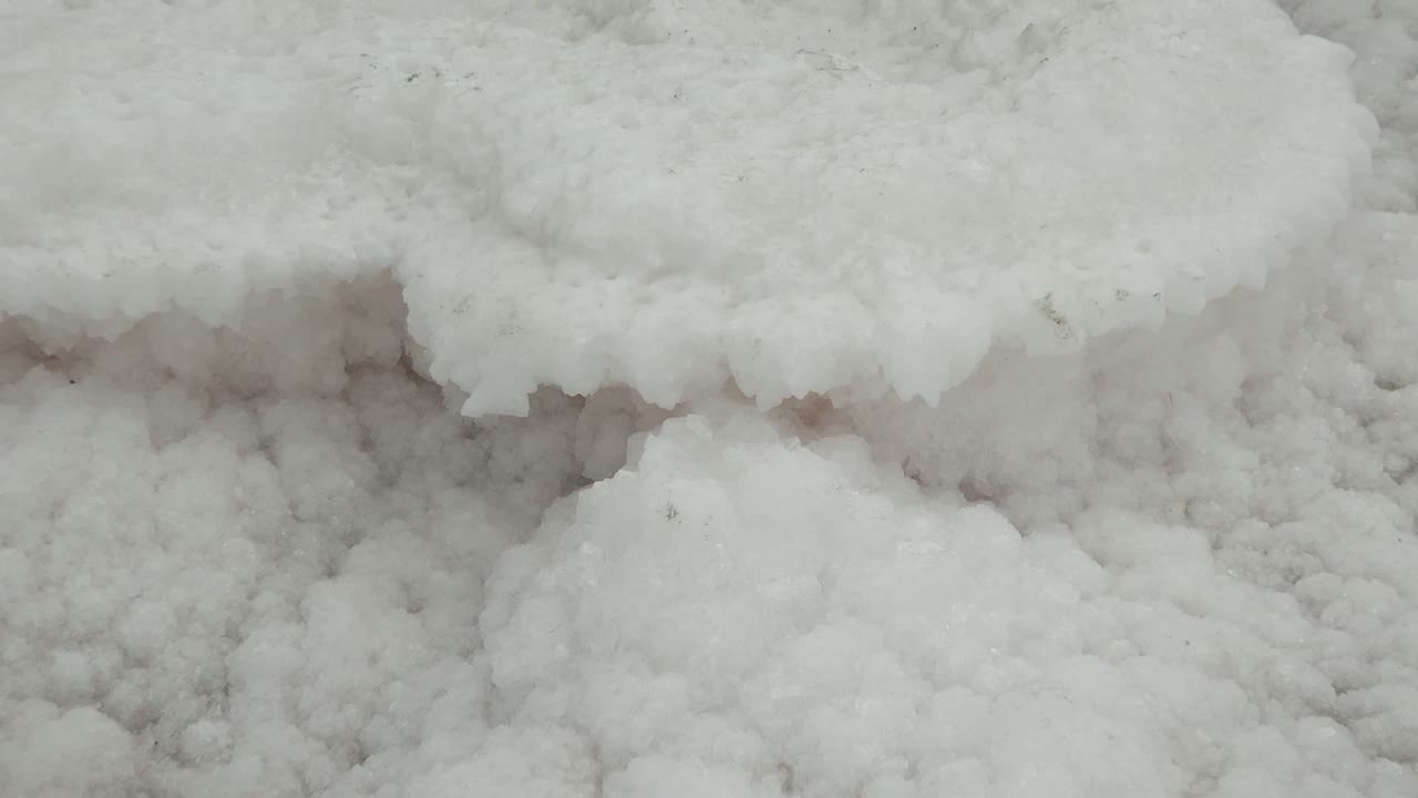 White ice shelf with uneven frozen texture below.