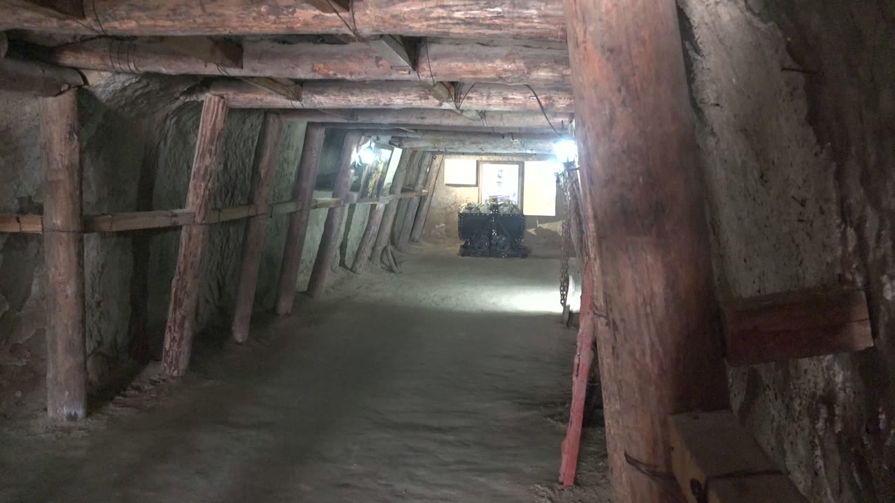 Santa Rosalia, Baja California Sur tunnel interior with rough walls, timber supports, a dirt floor, and no visible people at the opening moment.