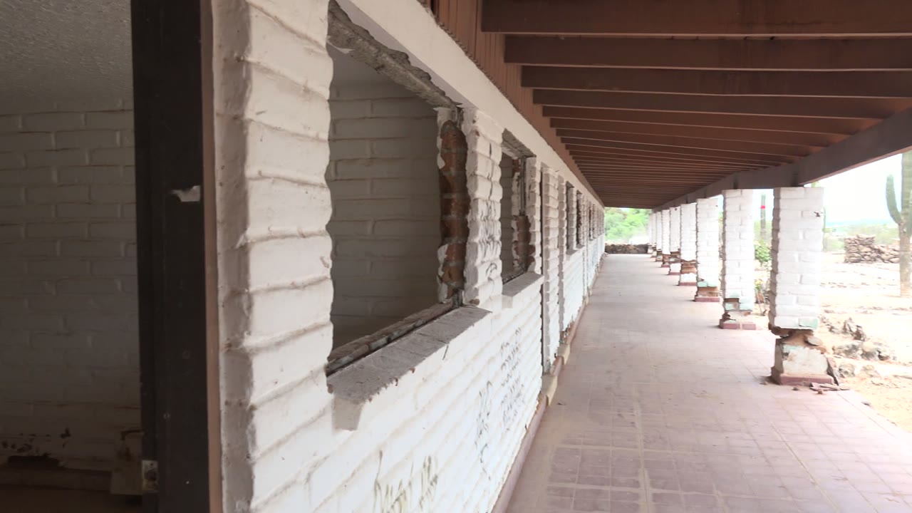 Covered walkway receding between white brick columns