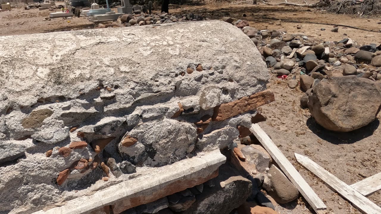 Concrete slab, loose rocks, and dirt work area