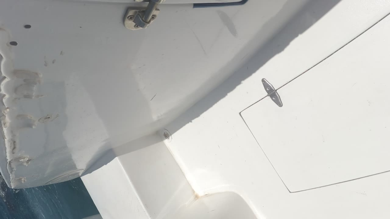 White deck panels, metal fittings, and part of the vessel structure appear in hard sunlight in Baja California, Mexico, with no visible people.